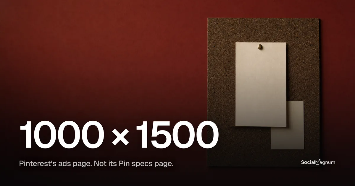 A tall blank cream card pinned to a cork board with a brass push-pin, against a deep red wall, with a smaller card behind it